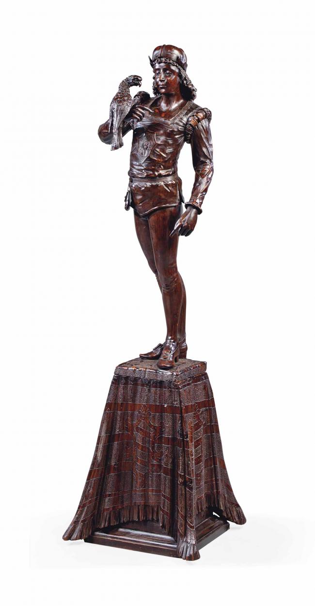  AN ITALIAN CARVED AND STAINED WOOD MODEL OF A FALCONER 