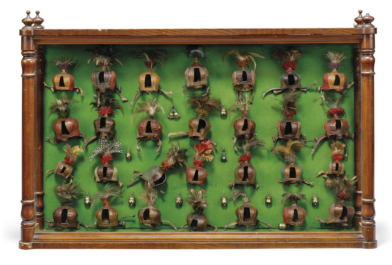 A DISPLAY OF TWENTY-EIGHT GERMAN FALCONRY HOODS MID-19TH CENTURY